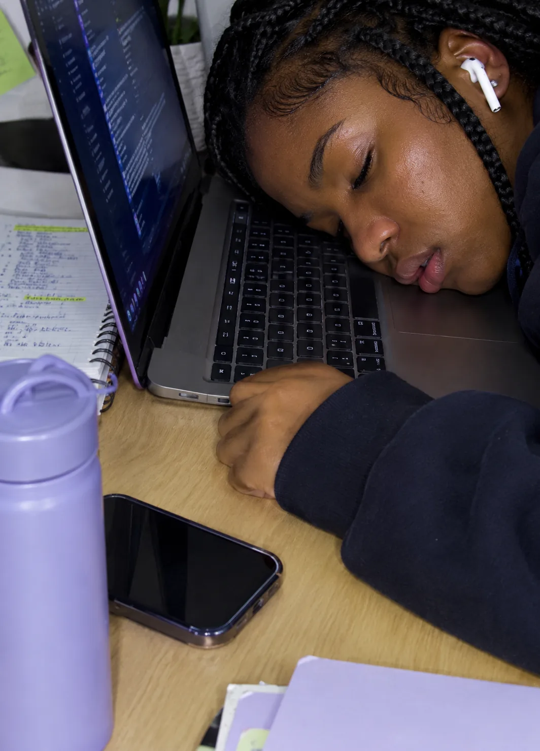 A student asleep on a laptop after hours of studying